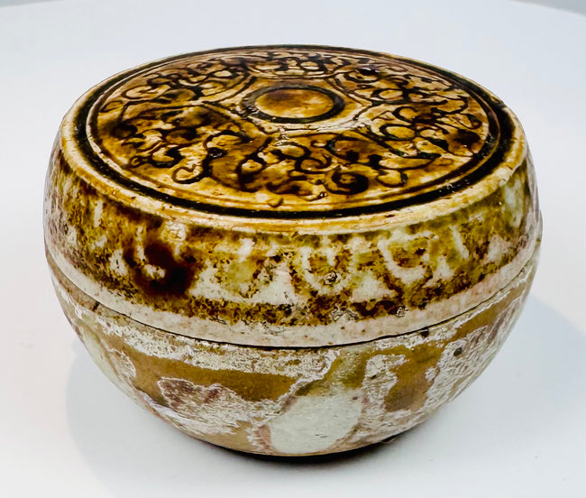 Small Sawankhalok lidded box showing its rounded body and domed cover