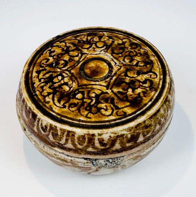 Front view of the Si Satchanalai ceramic box with foliate and scrolling decoration
