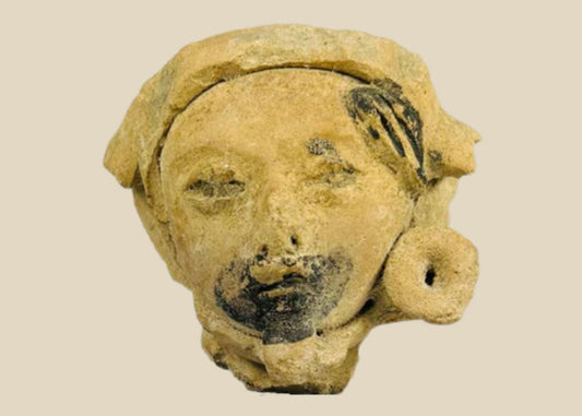 Late Classic Period Mesoamerican ceramic head fragment, circa 500–900 CE, with expressive facial features, traces of black pigment, and a detailed turban-like headpiece.
