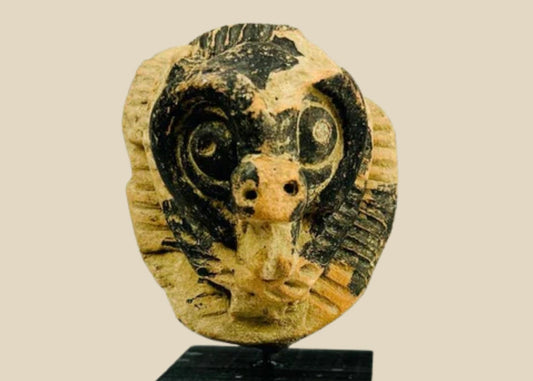 Pre-Columbian terracotta mask fragment from Mesoamerica, Classic Period (500–900 AD), depicting an animal face with bold eyes and snout, incised patterns, and traces of black pigment.