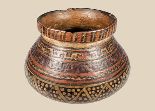 Mesoamerican polychrome redware bowl, circa 1st millennium CE, showing its broad opening and geometric painted bands