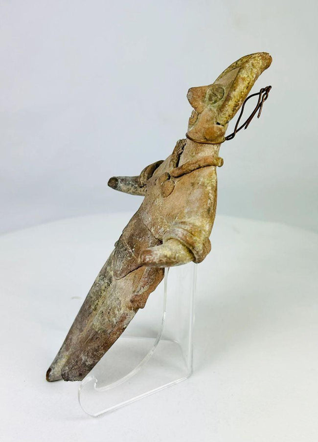Side profile showing incised torso detailing on a Mesoamerican ritual figurine