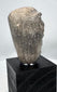 Mesopotamian pottery sculpture with raised forehead band and recessed mouth