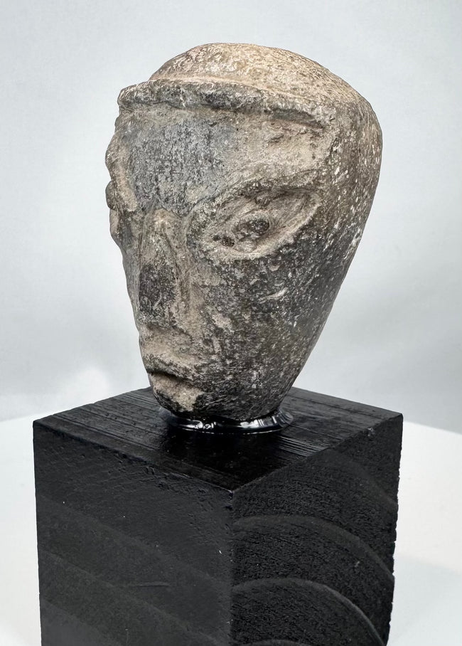 Ancient Mesopotamian sculptural head with elongated face and prominent nose