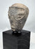Ancient Mesopotamian sculptural head with elongated face and prominent nose