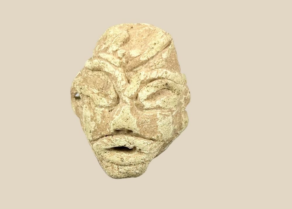 Ancient Mesopotamian carved stone idol head, 2000–800 BCE, Near East votive figure fragment with almond-shaped eyes and broad nose on display stand