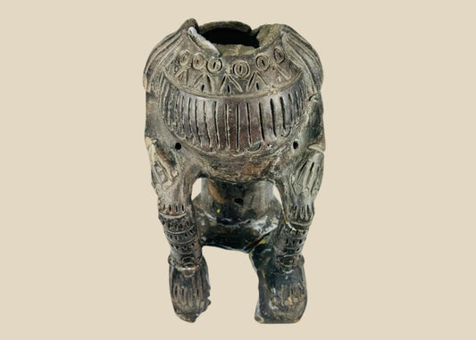 Terracotta figure in Chupicuaro style from West Mexico, mid-20th century, with hollow body, geometric incised motifs, pierced vent holes, and surface patina. A reproduction inspired by ancient Mesoamerican funerary and ceremonial sculpture.