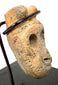 Close-up of porous bone grain and deep hollow eye cavity on pre-Columbian mask pendant