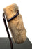 Rear view of tan carved bone pendant emphasizing top protrusions and metal ring support