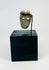 Ancient Mesoamerican bone mask pendant used as ritual amulet or funerary offering