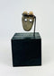 Ancient Mesoamerican bone mask pendant used as ritual amulet or funerary offering