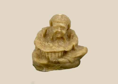 Early 20th century Egyptian revival Sphinx sculpture, reclining lion body with nemes headdress, hand-carved natural material mounted on black wooden base, decorative Egyptomania piece