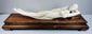 Side profile of the ivory-toned Chinese female sculpture resting against its fitted carved pillow
