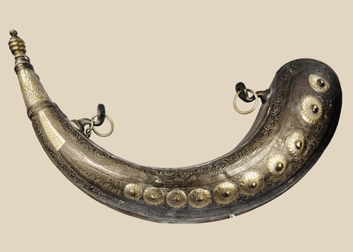 Antique Moroccan brass powder horn with crescent-shaped body and engraved floral decoration