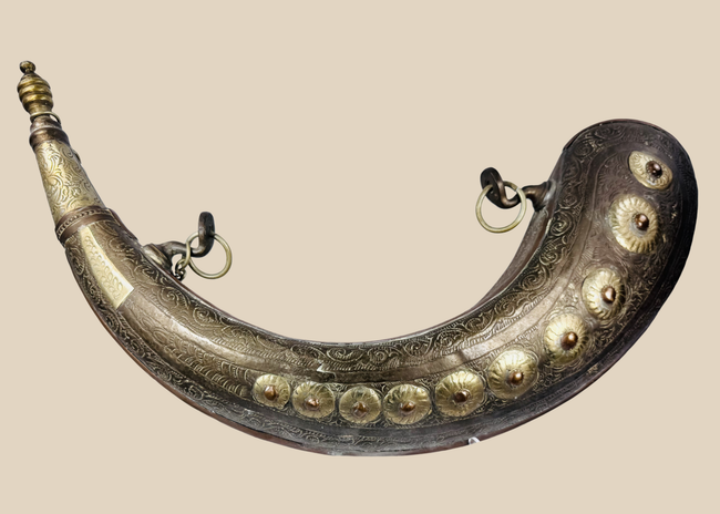 Antique Moroccan brass powder horn with crescent-shaped body and engraved floral decoration