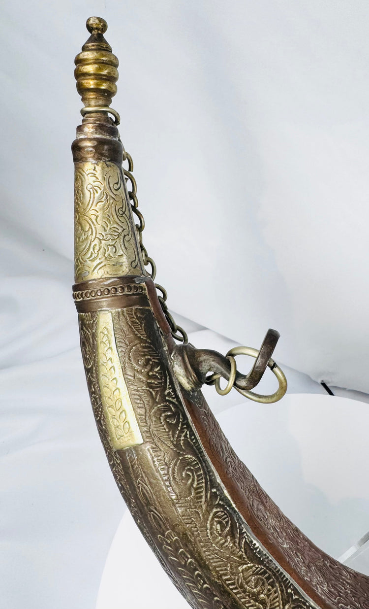 Engraved Moroccan gunpowder container with crescent profile and copper-toned surface