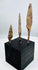 Small triangular iron arrowhead with short tang and mineral encrustation