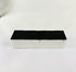 Authentic NASA Space Shuttle Thermal Protection System (TPS) tile from the 1980s, made of silica-based ceramic with black Reaction Cured Glass coating, used for reentry heat resistance, preserved in NASA-issued display case.