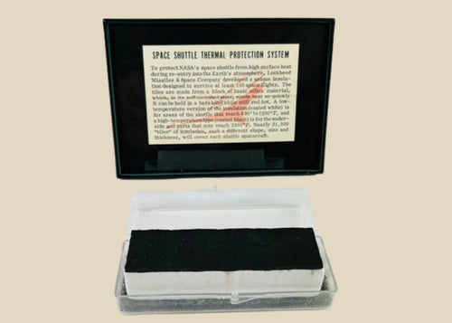 Authentic NASA Space Shuttle HRSI tile from the 1980s, silica-based ceramic with black Reaction Cured Glass (RCG) coating, designed for high-temperature reentry, displayed in original NASA-issued case with documentation.