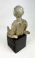 Pre-Columbian Nayarit seated male sculpture with crossed legs and stylized features