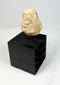 Ancient Mesopotamian stone idol head, ritual votive fragment from the Near East, displayed on stand
