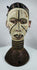 Nigerian Igbo ceremonial crest with dual-faced human forms and traces of original pigment decoration.
