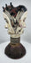 Traditional Igbo masquerade crest with opposing faces, projecting coiffure elements, and aged patina.