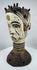 Nigerian ceremonial headdress featuring a dual-faced carved design, ringed neck, and perforated base.