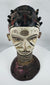 African ceremonial dance crest from the Igbo people with opposing faces and traditional masquerade construction.