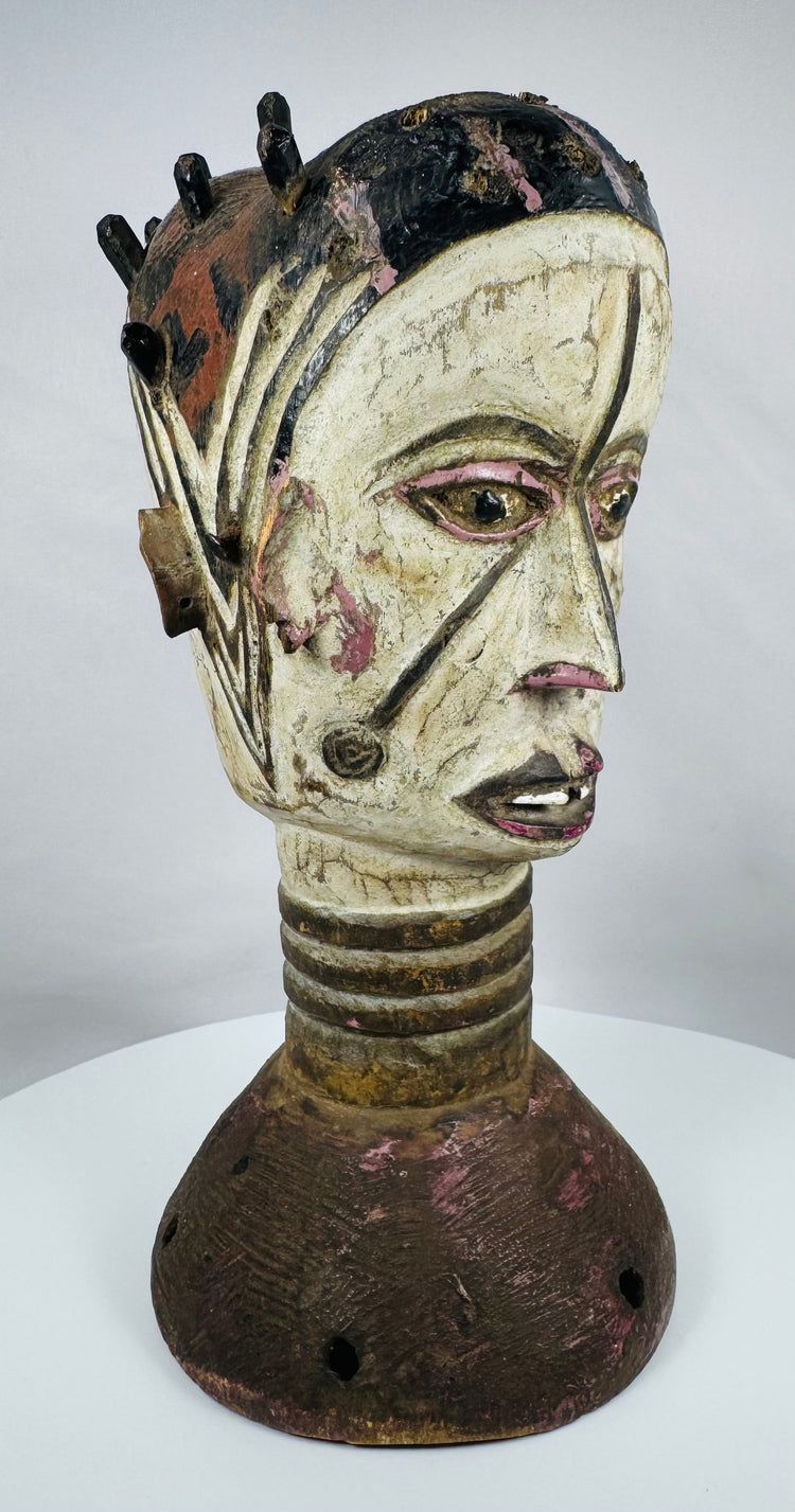 Hand-carved wooden Janus dance crest from Nigeria showcasing ritual symbolism and painted geometric motifs.