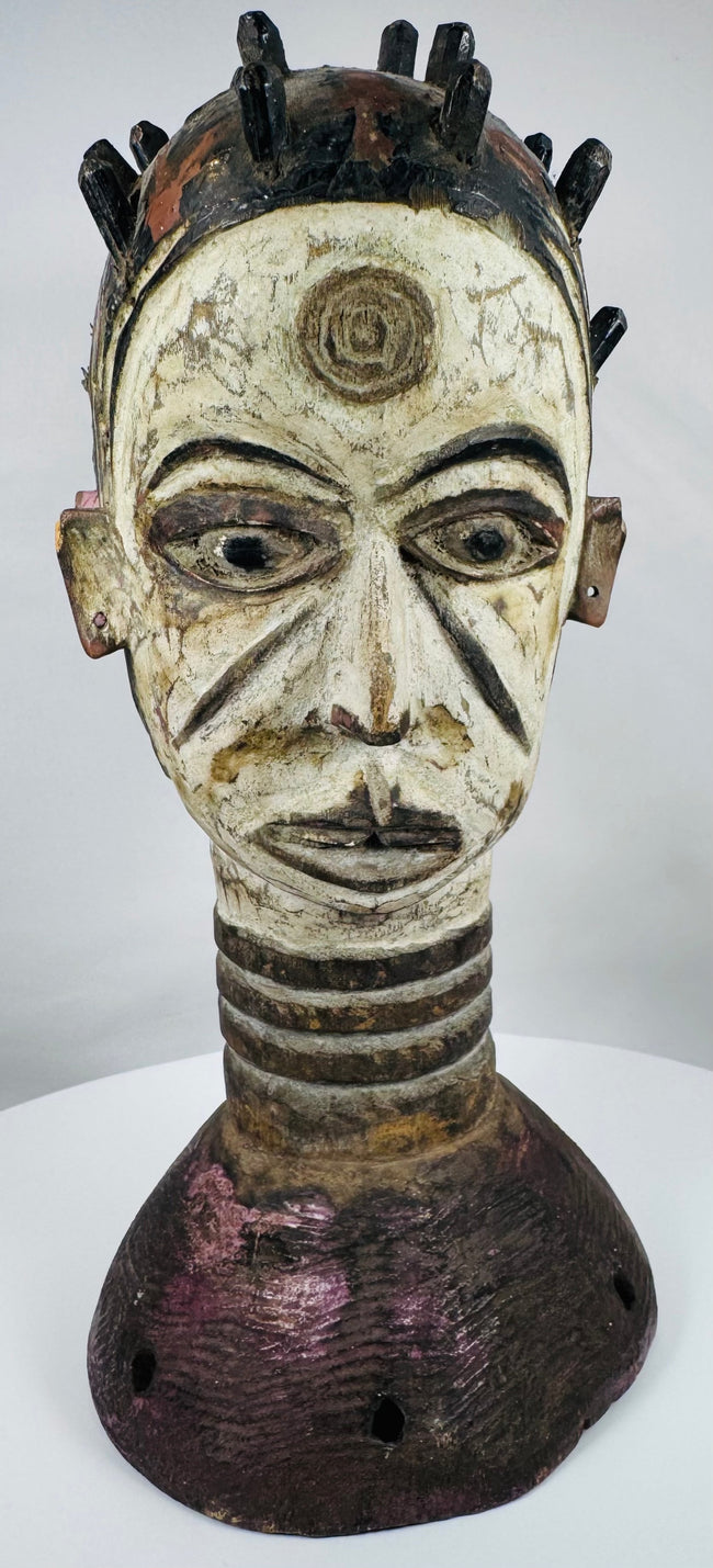 Igbo wooden Janus crest with white, black, red, and purple pigments used in ceremonial performances.
