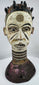 Igbo wooden Janus crest with white, black, red, and purple pigments used in ceremonial performances.