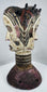 Mid-century Igbo masquerade headdress featuring a carved Janus head design and weathered surface patina.