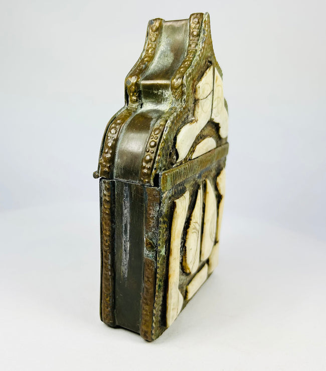19th century Berber tribal amulet holder, brass repoussé work with protective geometric symbols.