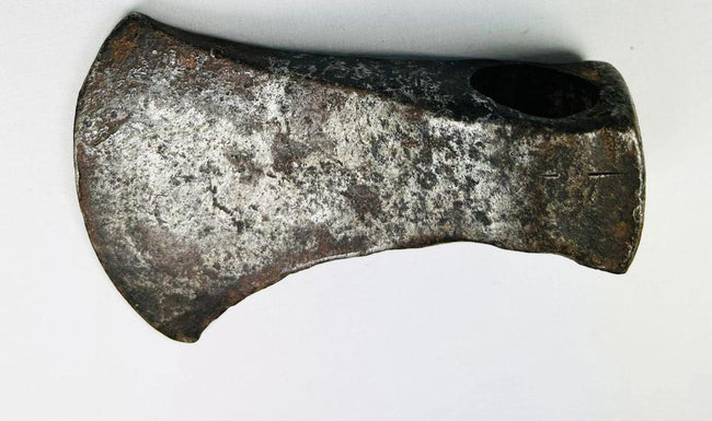 Antique 19th-century axe head with curved blade design and frontier-era wear from daily woodcutting use.