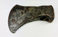 Forged iron axe head used by early settlers, showing authentic patina and handcrafted construction.