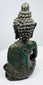 Back view of the Northern Thai bronze Buddha with mineral deposits and oxidation