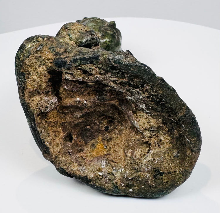 Open underside of the lost-wax cast Buddha showing accretions and casting-core remnants