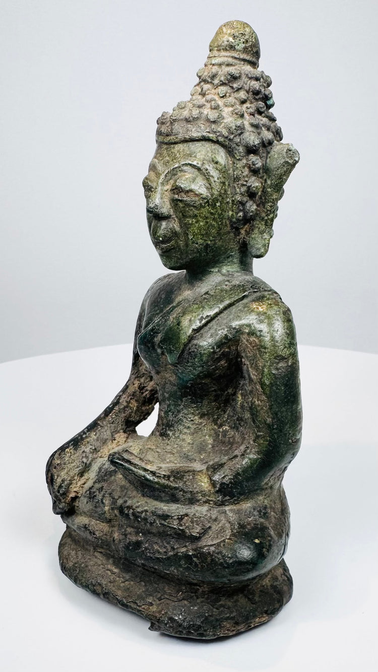 Three-quarter view of the Northern Thai Buddha with brown and green patina