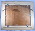 Painting’s reverse showing the panel backing, frame fittings and hanging wire.