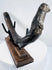 Prehistoric marine mammal rib fossil presented on a custom wood and metal display stand