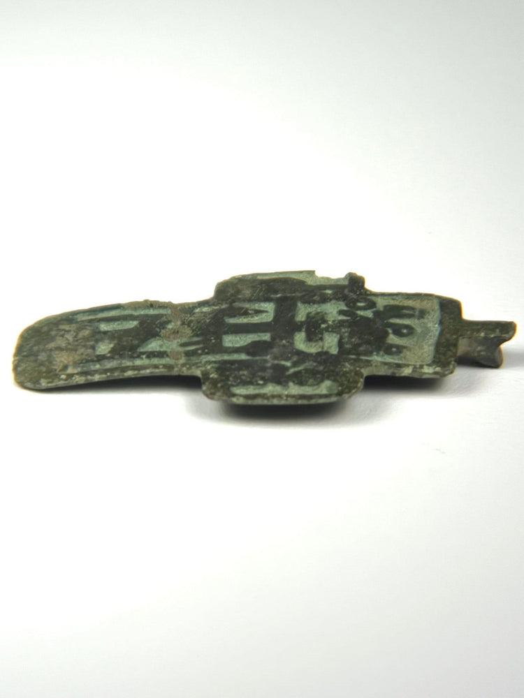 Angled view highlighting relief of enamel inlays on historic cross pendant
