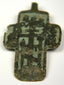Close-up of green and black champlevé enamel details on antique cross