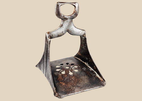 Authentic 17th-century Ottoman forged steel stirrup with triangular form, openwork floral cut-out footplate, and traces of silver damascening; historically used by elite cavalry for mounted combat and control.