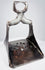 17th-century Ottoman forged steel stirrup with triangular form, pierced floral footplate, and traces of silver damascening.