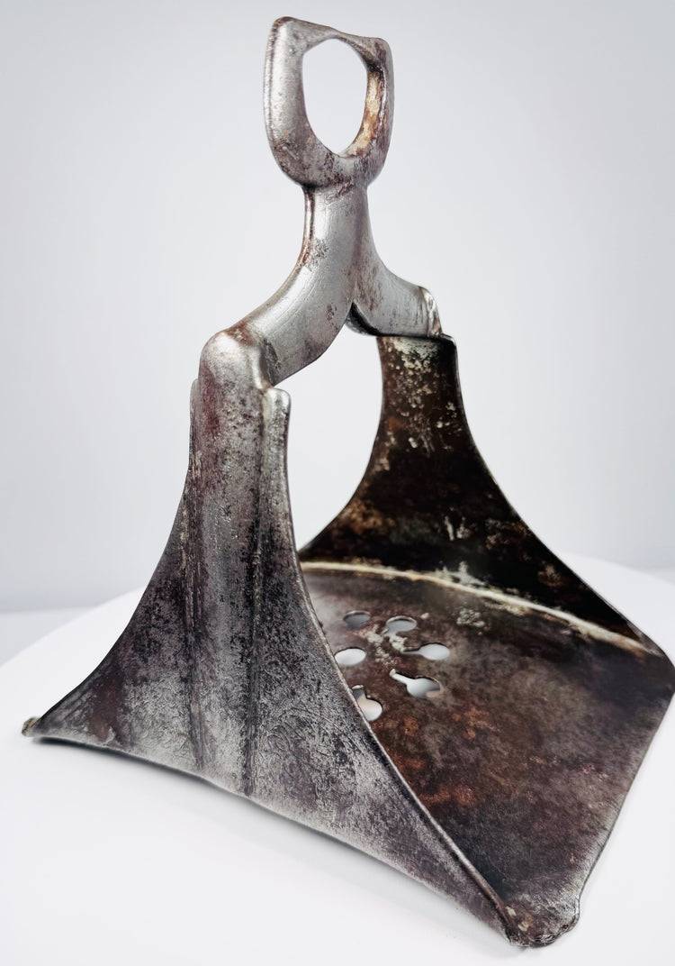 Antique Ottoman cavalry stirrup in forged steel with openwork decoration and surviving silver inlay.