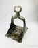Historic Ottoman stirrup with floral perforated footplate and curved suspension loop, photographed upright.