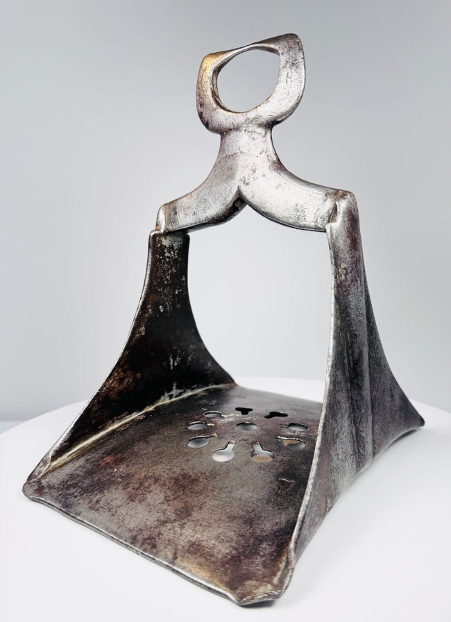 Antique Turkish Ottoman cavalry stirrup with forged steel body and decorative footplate designed for grip and stability.