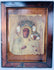 Antique icon of Our Lady of Częstochowa with painted faces, gilded details, and elaborate metal covering.