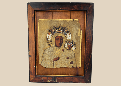 19th-century Eastern European icon depicting Our Lady of Częstochowa holding the Christ Child beneath an ornate metal riza.